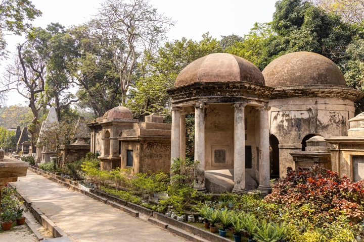 Gothic tombs and overgrown vines in South Park Street Cemetery, Kolkata.