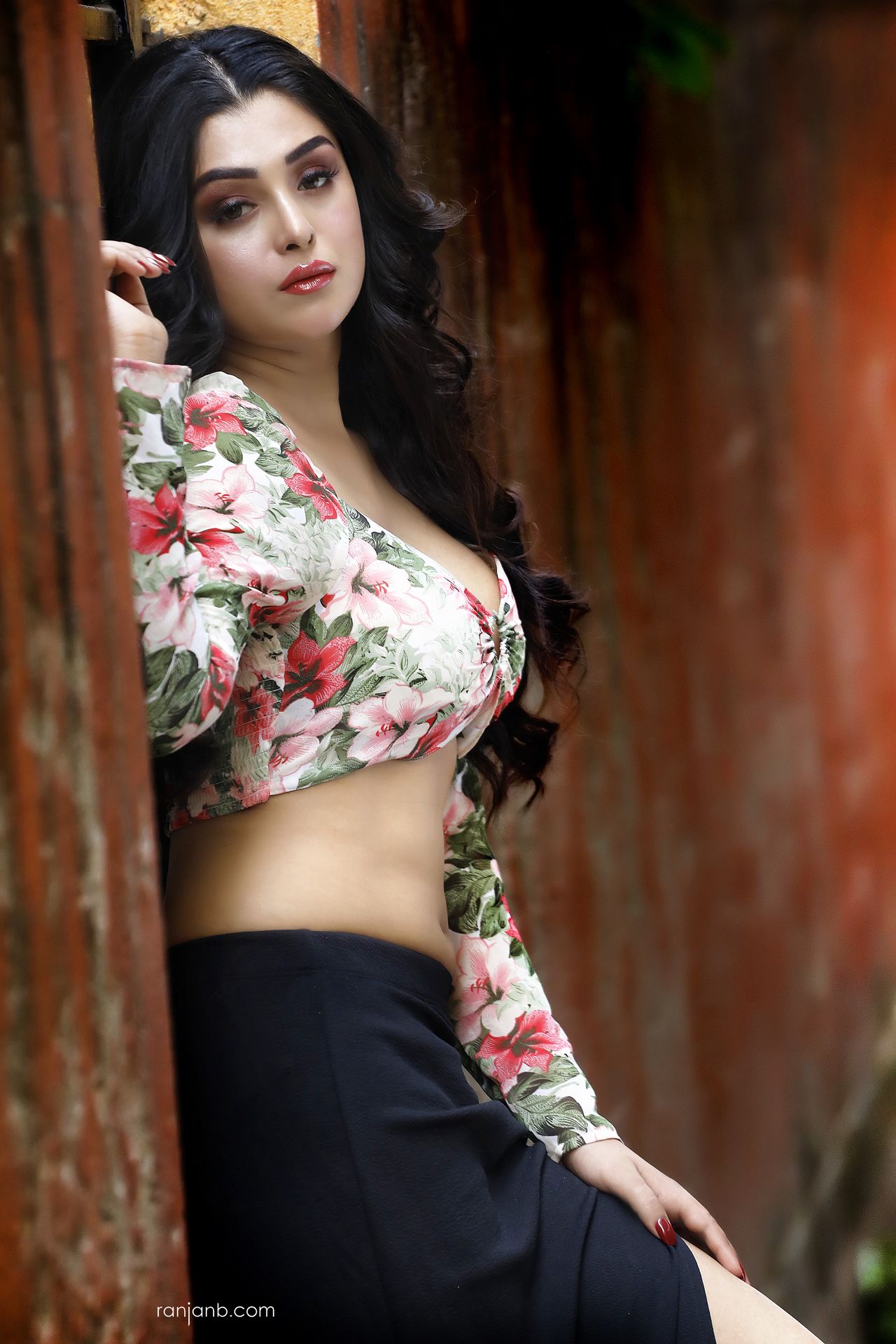 Praniya Paul poses in a floral top and black skirt during an outdoor portfolio shoot by Ranjan Bhattacharya, capturing the 2025 retro-inspired bold color trend.