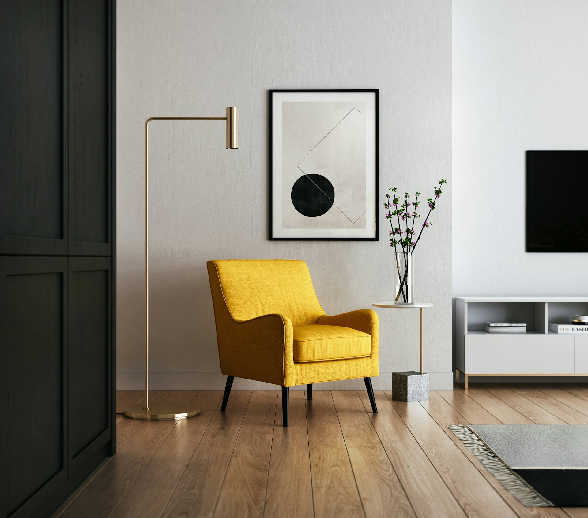 Modern living room with natural light, brown wood flooring, and a yellow padded chair.