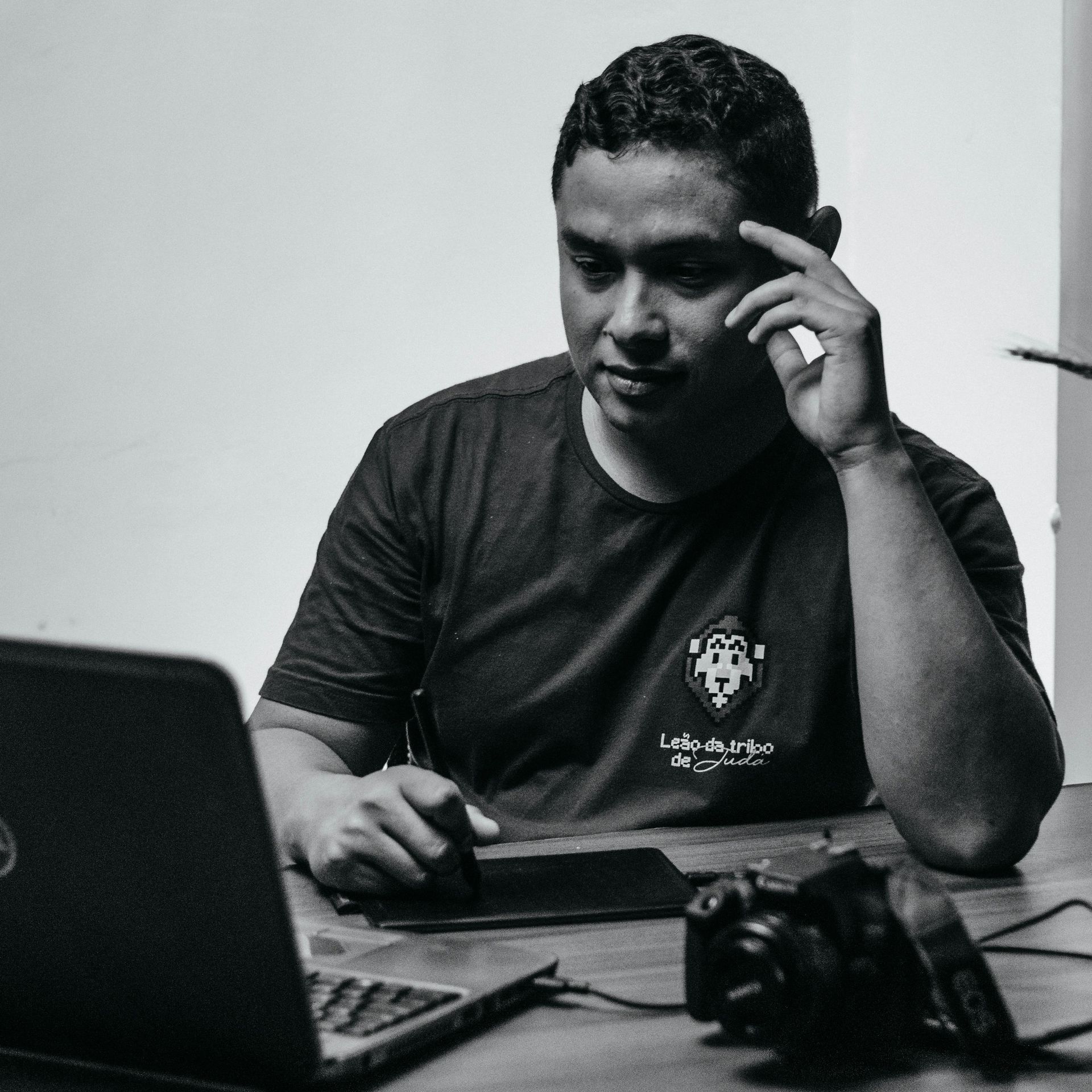 Photographer comparing website builder platforms on a laptop at desk