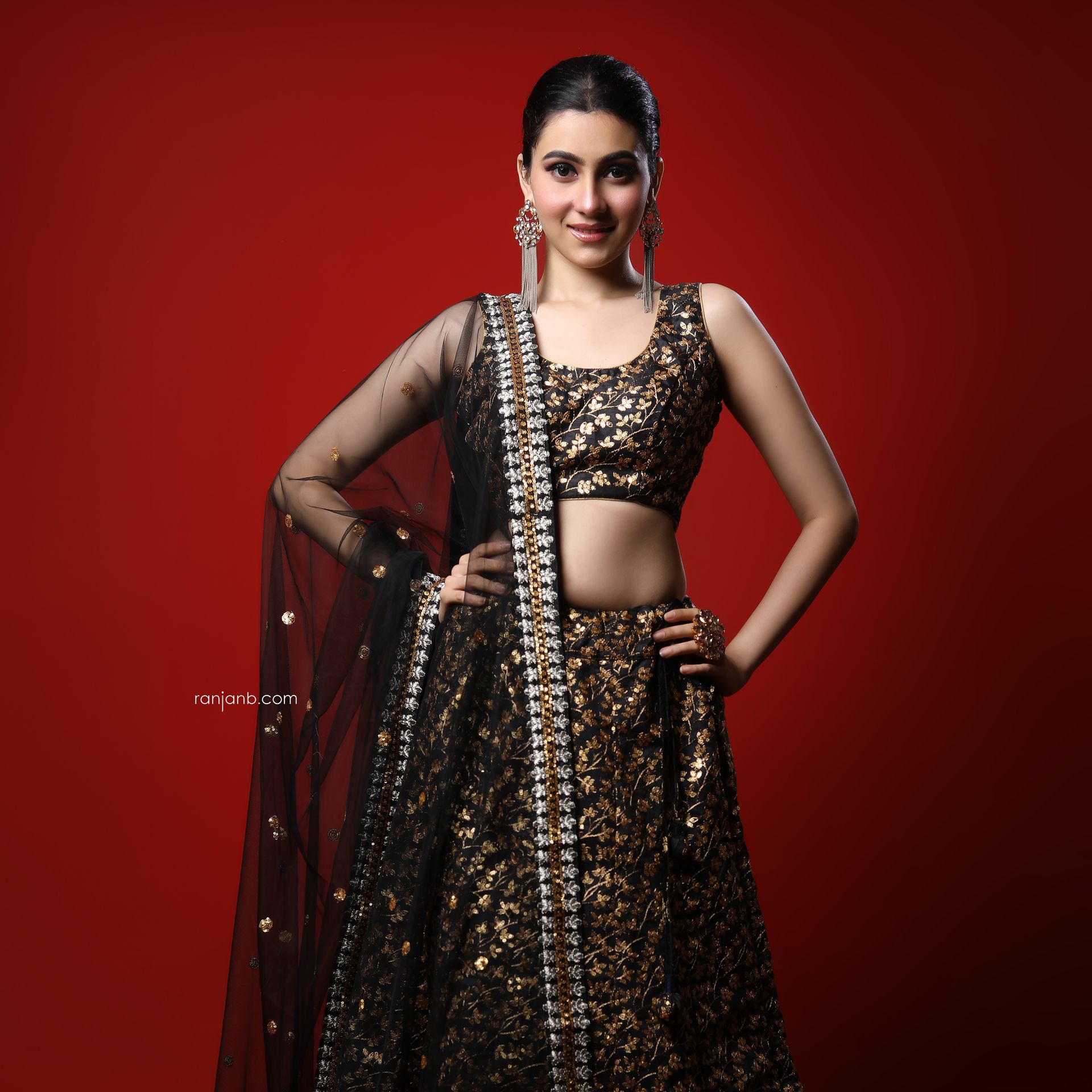 Nayonika Gangoly in a red ghagra choli against a dramatic backdrop, styled by Nanda Majumdar, reflecting her growing confidence and vibrant personality in this Kolkata portfolio shoot by Ranjan Bhattacharya.