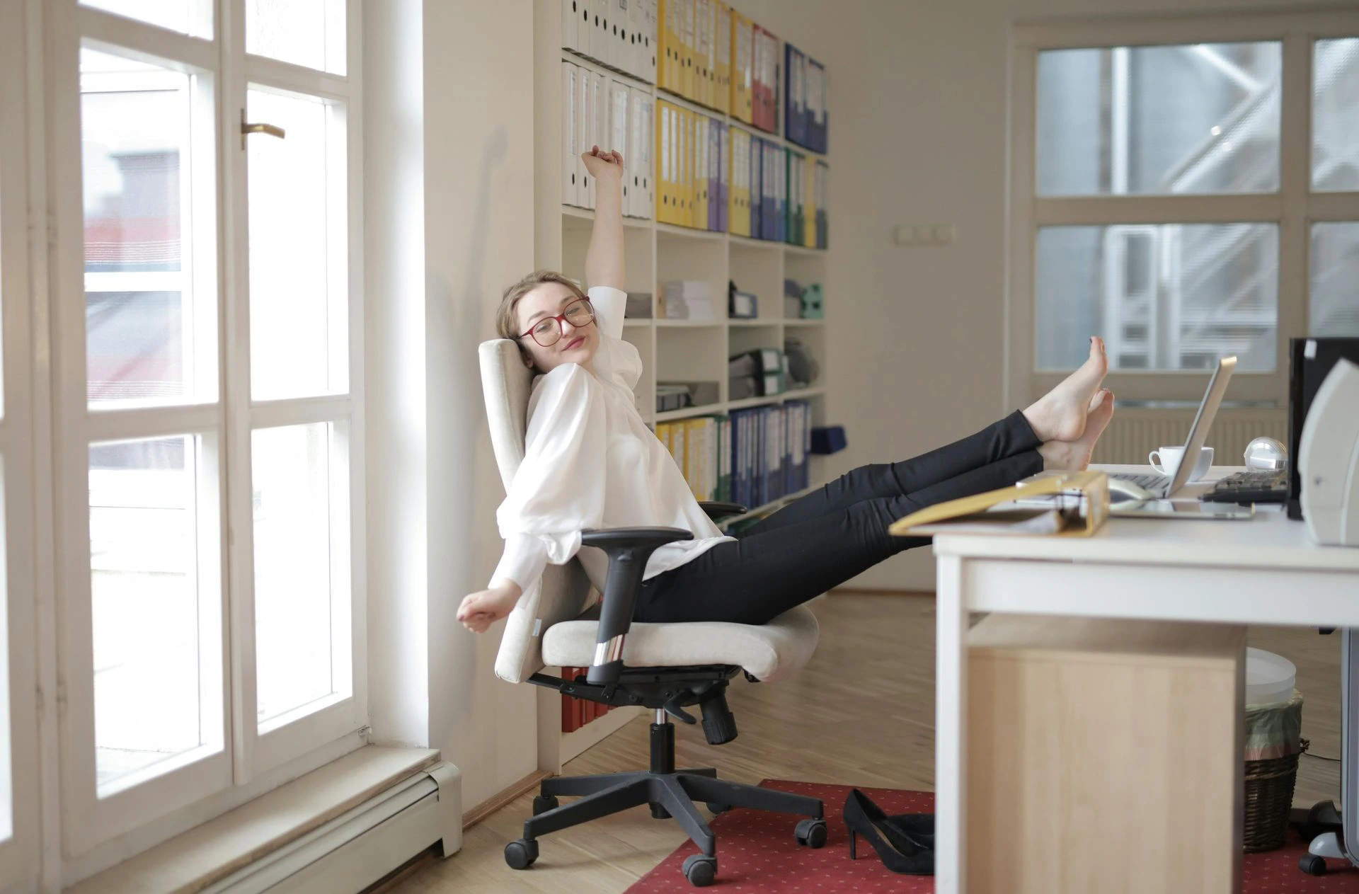 A professional relaxing at her desk after work, symbolising balanced personal branding and healthy boundaries in 2026