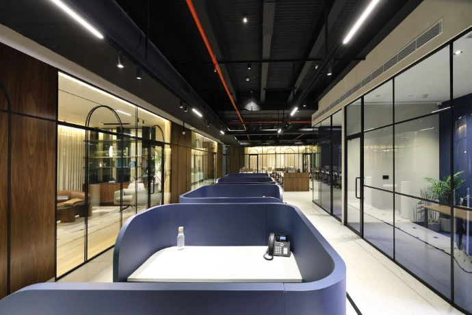 Corporate interior photography showcasing open office corridor and workstations