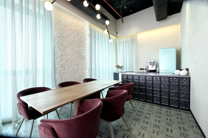 A thoughtfully designed office cafeteria that balances functionality, warmth, and everyday employee interaction Corporate office cafeteria with shared dining table, soft lighting, and a warm yet functional interior design