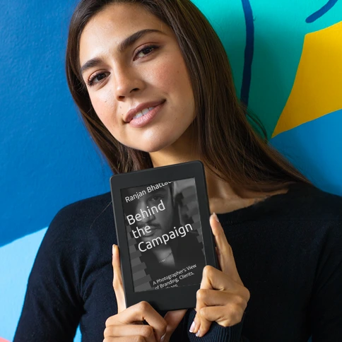 Woman holding 'Behind the Campaign' book by Ranjan Bhattacharya