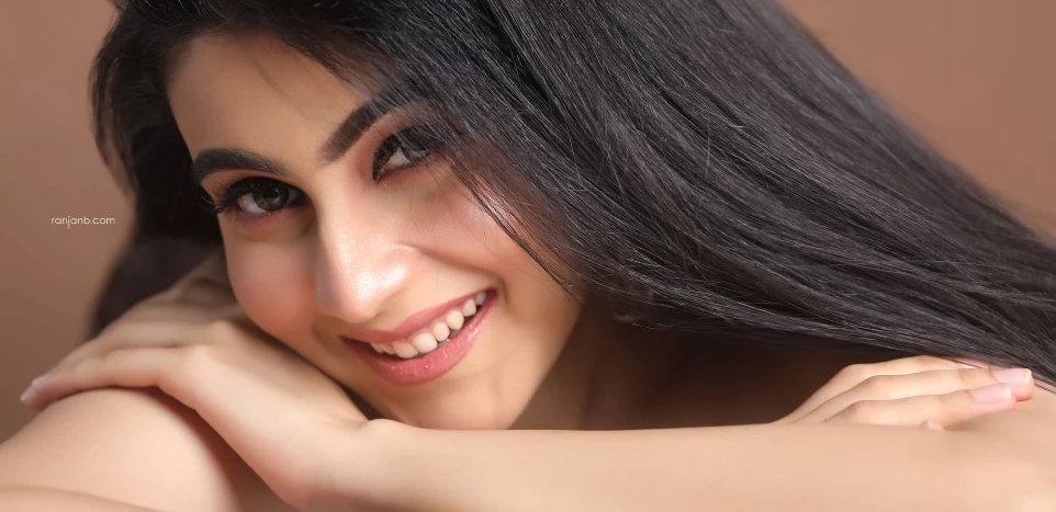 Nayonika's professional modelling portfolio shot in Kolkata by Ranjan Bhattacharya. Close-up beauty portrait of a smiling Indian model for fashion and commercial campaigns.