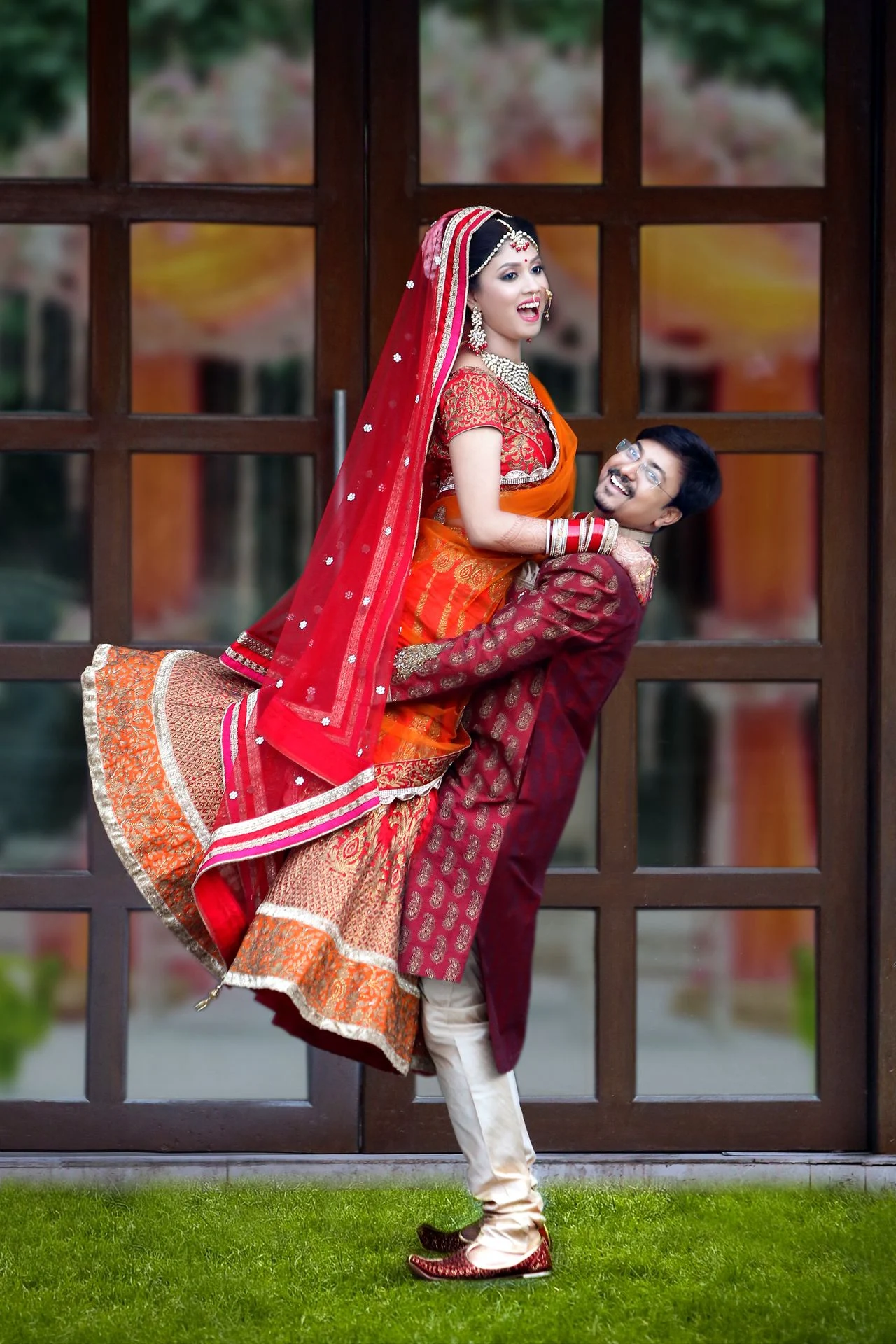 Joyful Wedding Moment: Dr Souvonik Lifting Dr Debarati - Captured by Ranjan Bhattacharya A joyful wedding moment where a guy lifts his fiancée, captured by photographer Ranjan Bhattacharya.