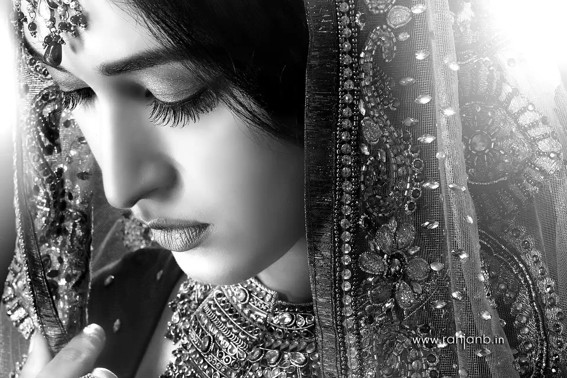 A close-up portrait of a woman in a traditional saree, highlighting her natural beauty, photographed by Ranjan Bhattacharya.