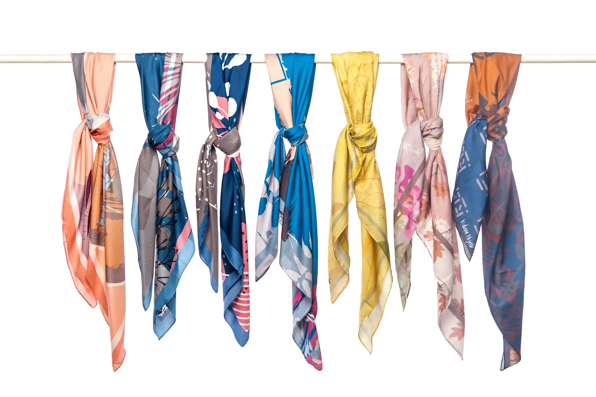 A row of scarves hanging from a clothesline at Utsav Fashion, Photographed by the best Product Photographer, Ranjan Bhattacharya