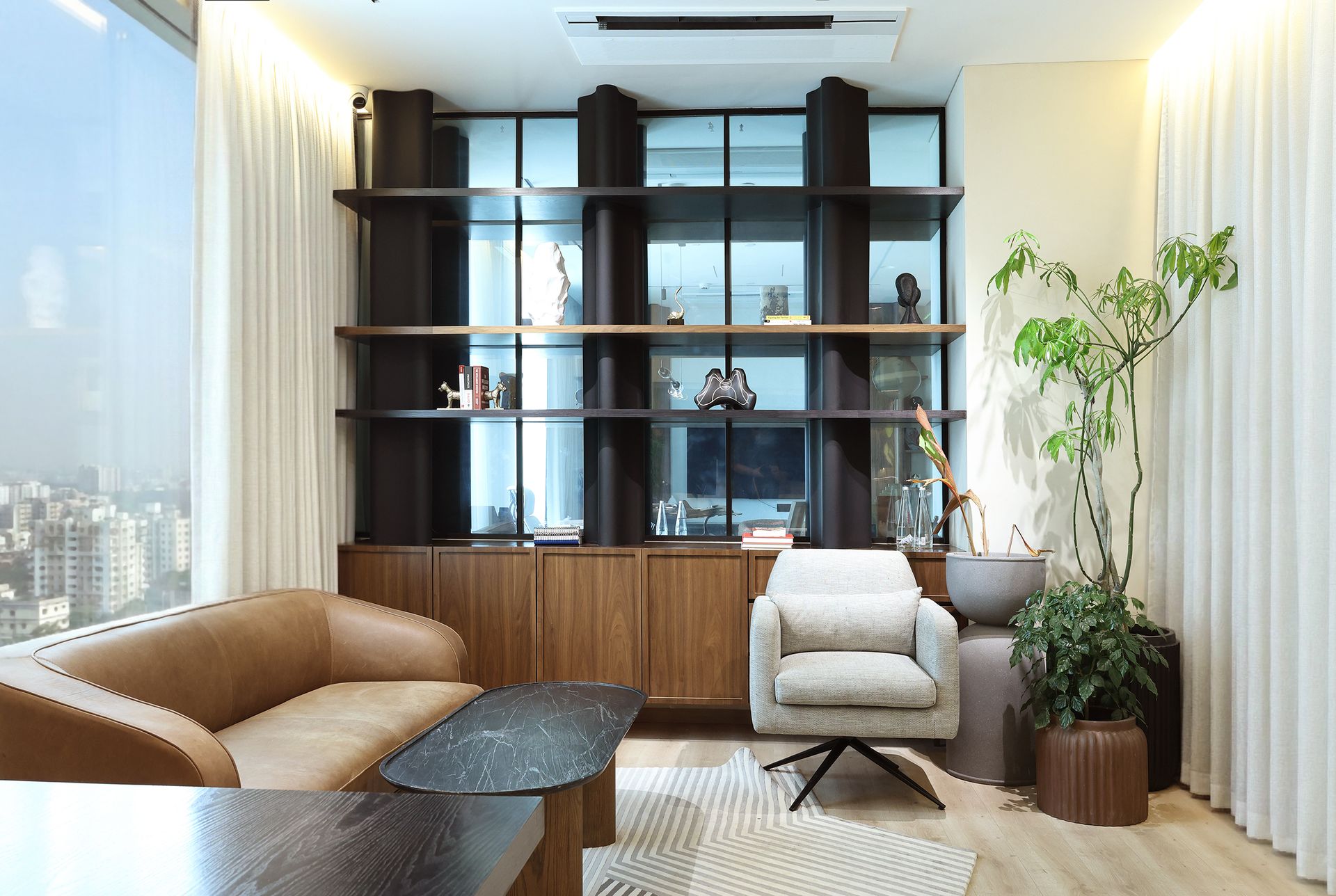 Interior photography of a modern corporate office at Khemka House, Kolkata designed by Green Square Turnkey Solutions featuring lounge seating and city view.