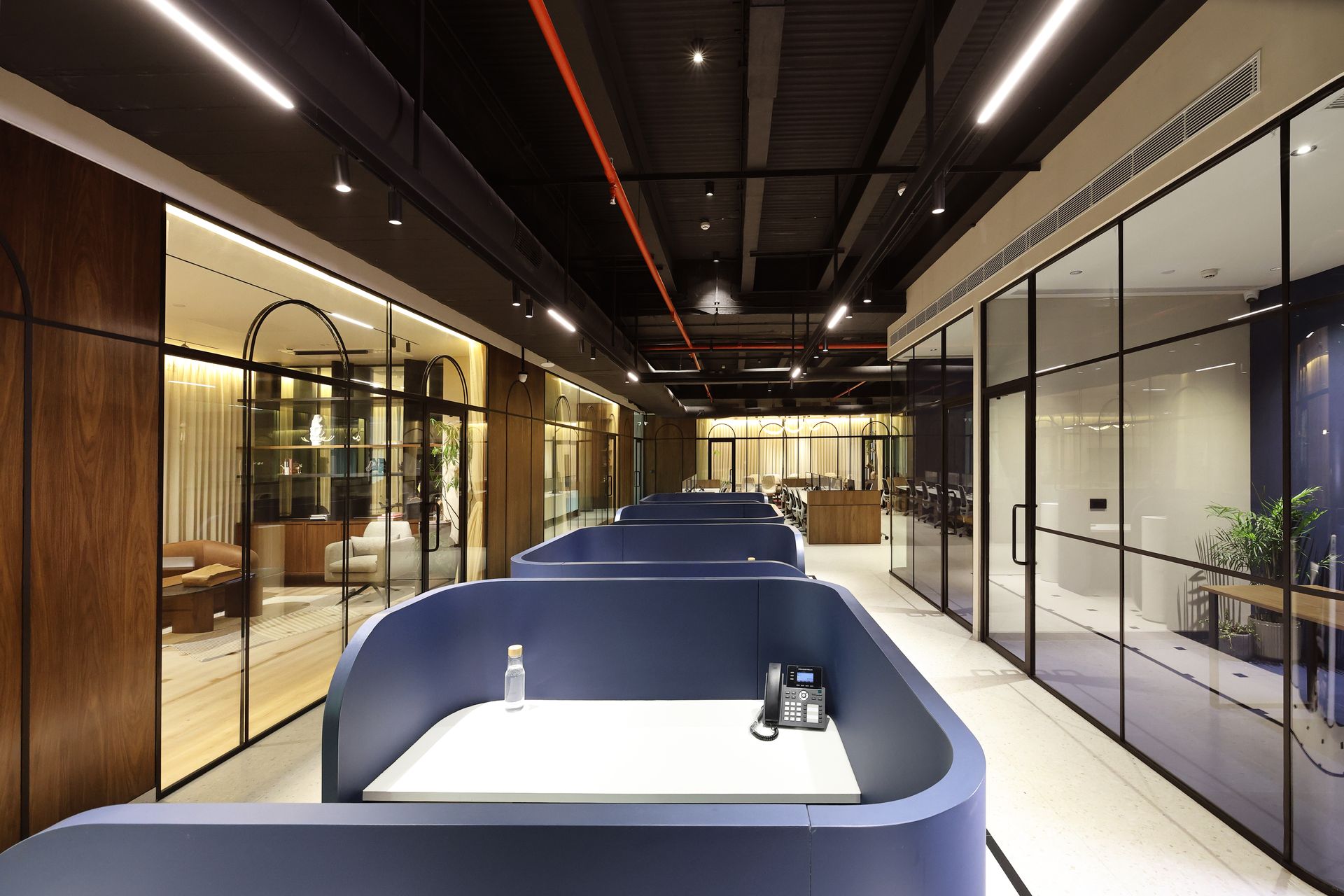 Corporate interior photography showcasing open office corridor and workstations