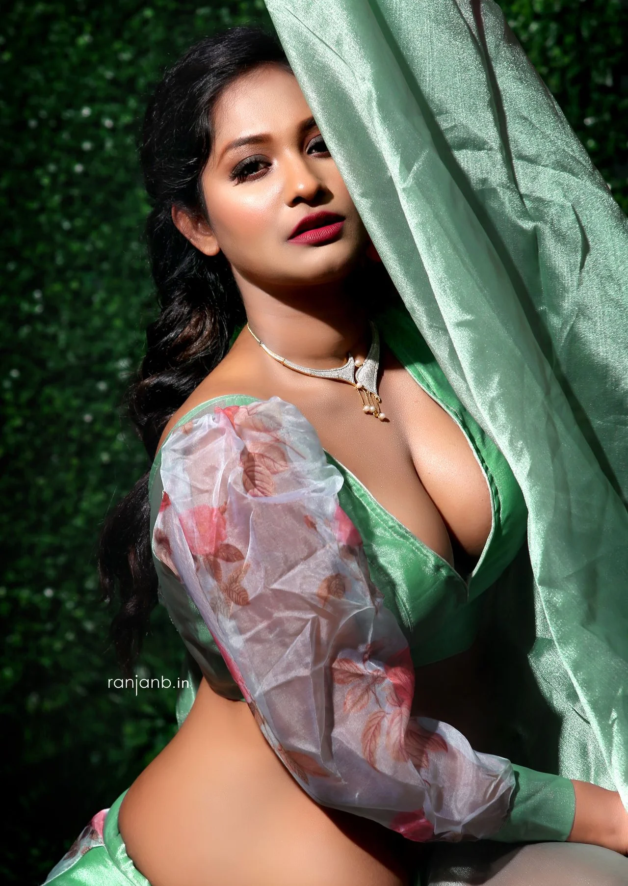 A striking portrait of Tania Guhathakurta, elegantly posed in a green outfit with floral sleeves, photographed by Ranjan Bhattacharya.