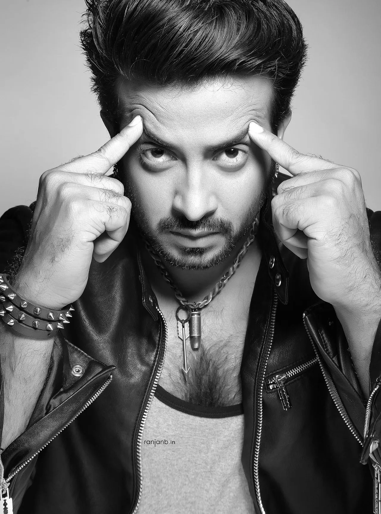 A dramatic black-and-white close-up of Shakib Khan, the renowned superstar of Bangladesh, captured by Ranjan Bhattacharya, Kolkata's leading fashion photographer.