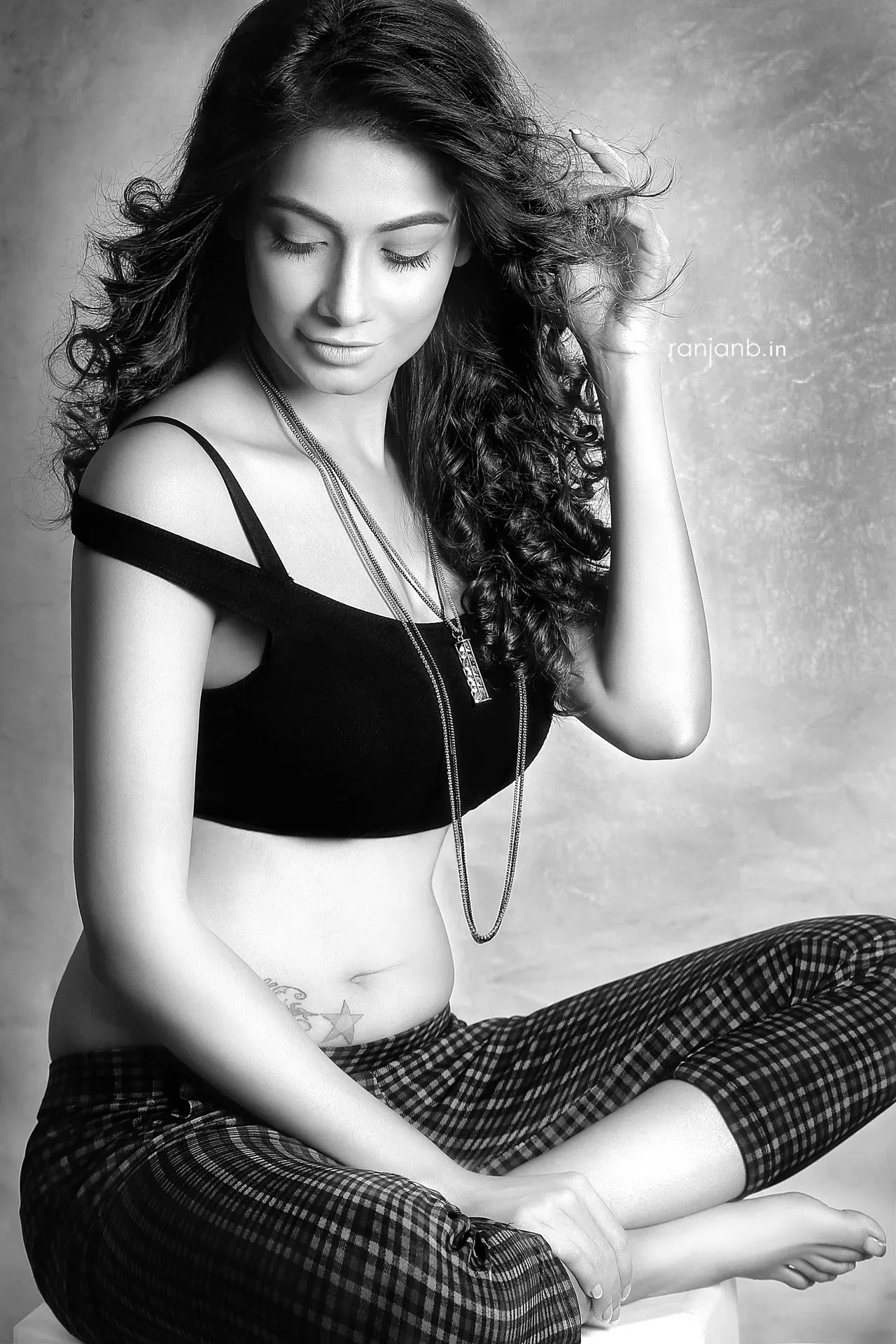 Captivating in Black and White, Sumana Singh exudes Elegance and Poise A stylish woman in a black top and plaid pants, photographed by Ranjan Bhattacharya, featuring Sumana Singh.