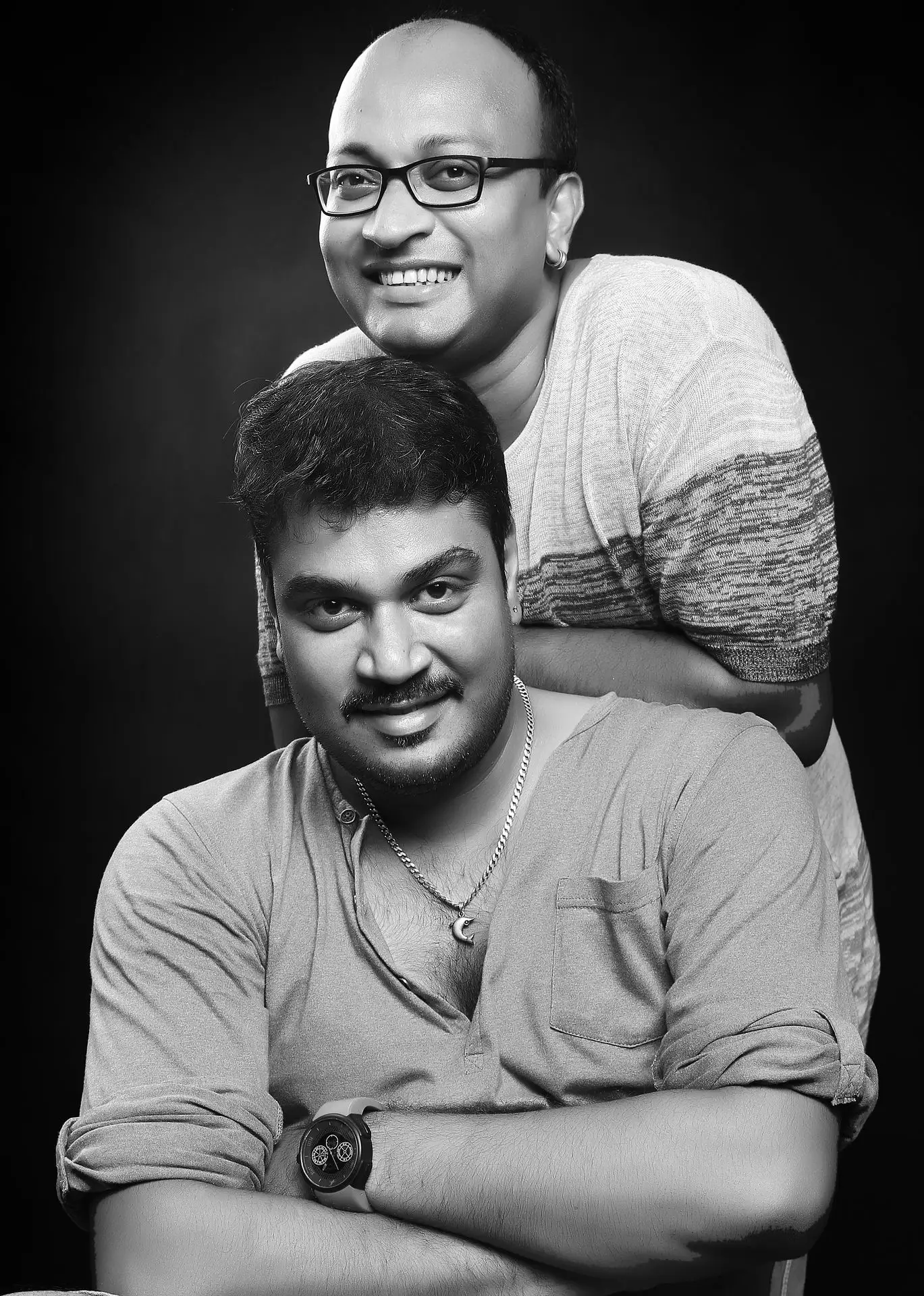 A Striking Black-And-White Portrait of Ranjan Bhattacharya and Nanda Majumdar. Ranjan Bhattacharya and Nanda Majumdar captured in a portrait, reflecting their personalities and formal attire.