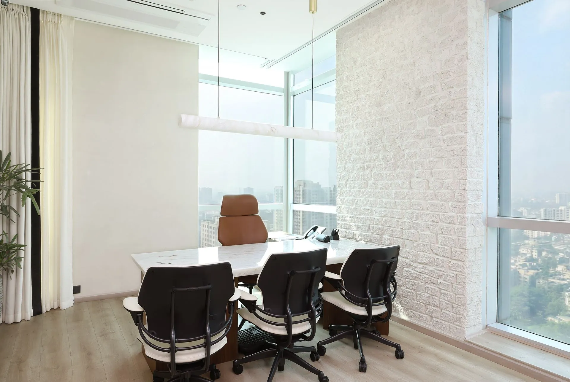 Corporate office interior at Khemka House, Kolkata designed by Green Square Turnkey Solutions featuring executive cabin with marble desk and panoramic city view.