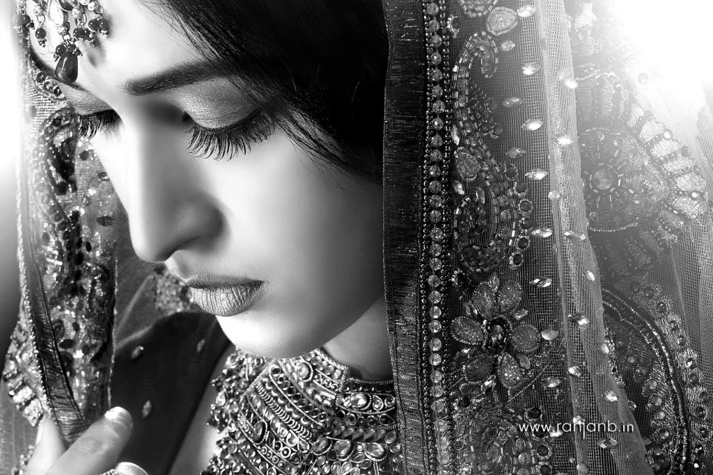A close-up portrait of a woman in a traditional saree, highlighting her natural beauty, photographed by Ranjan Bhattacharya.