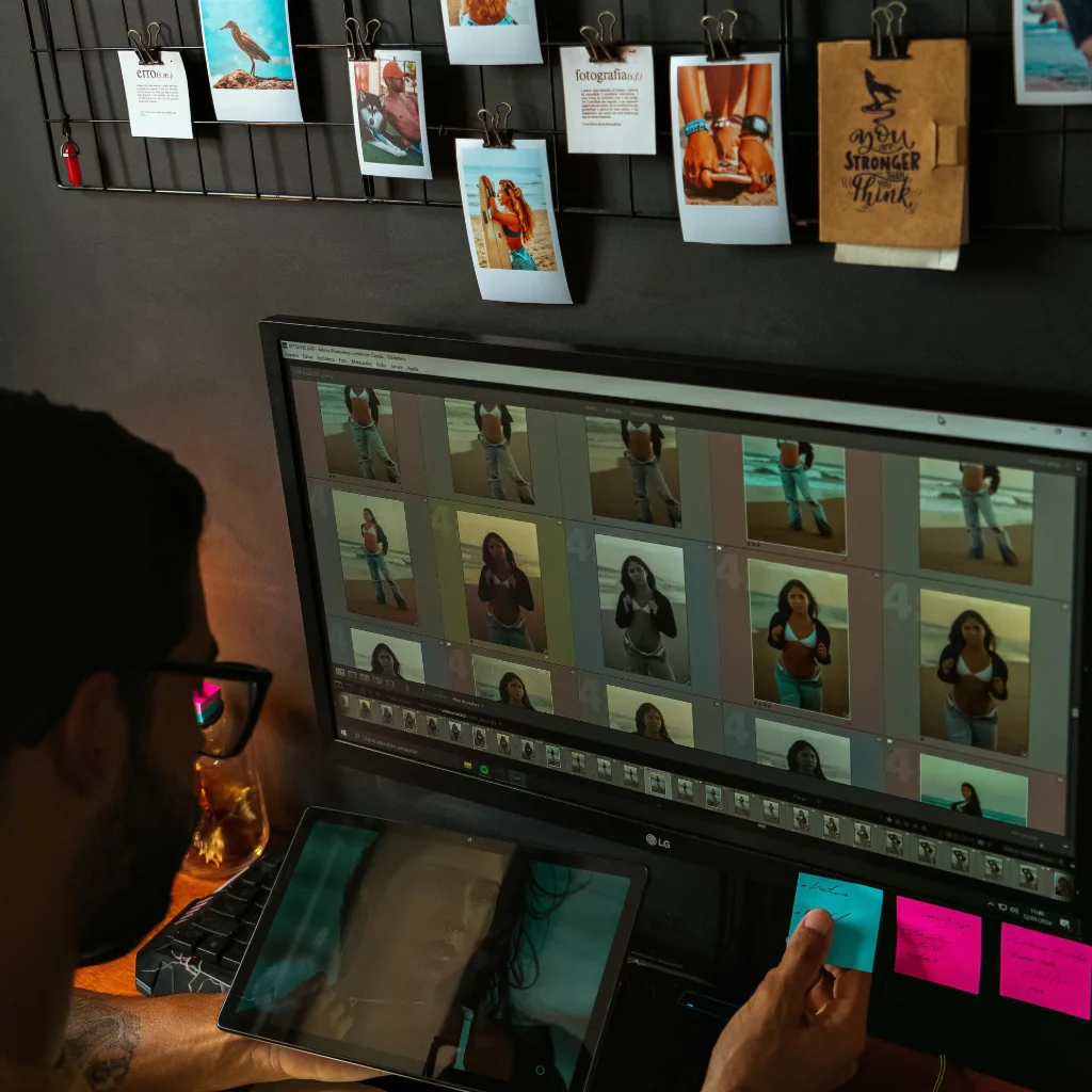 Photographer customizing portfolio website using a website builder on computer