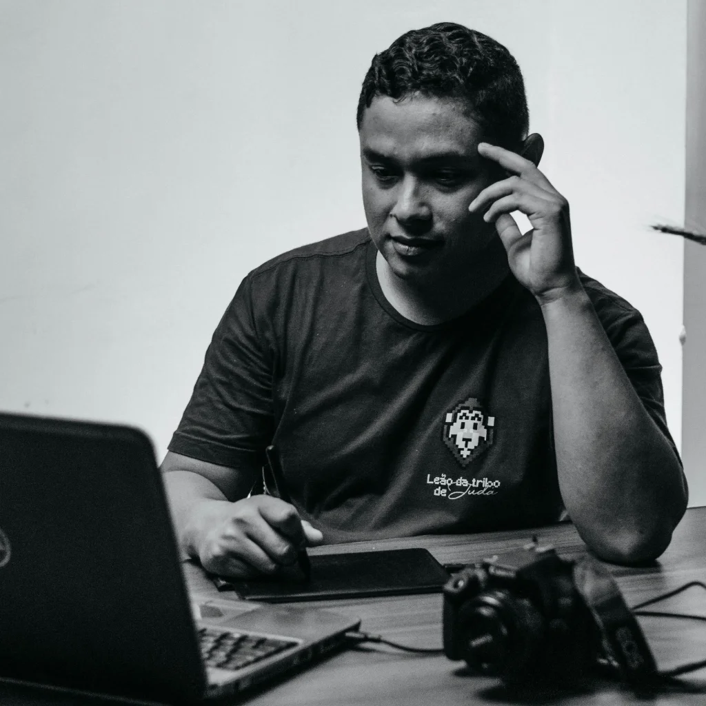 Photographer comparing website builder platforms on a laptop at desk