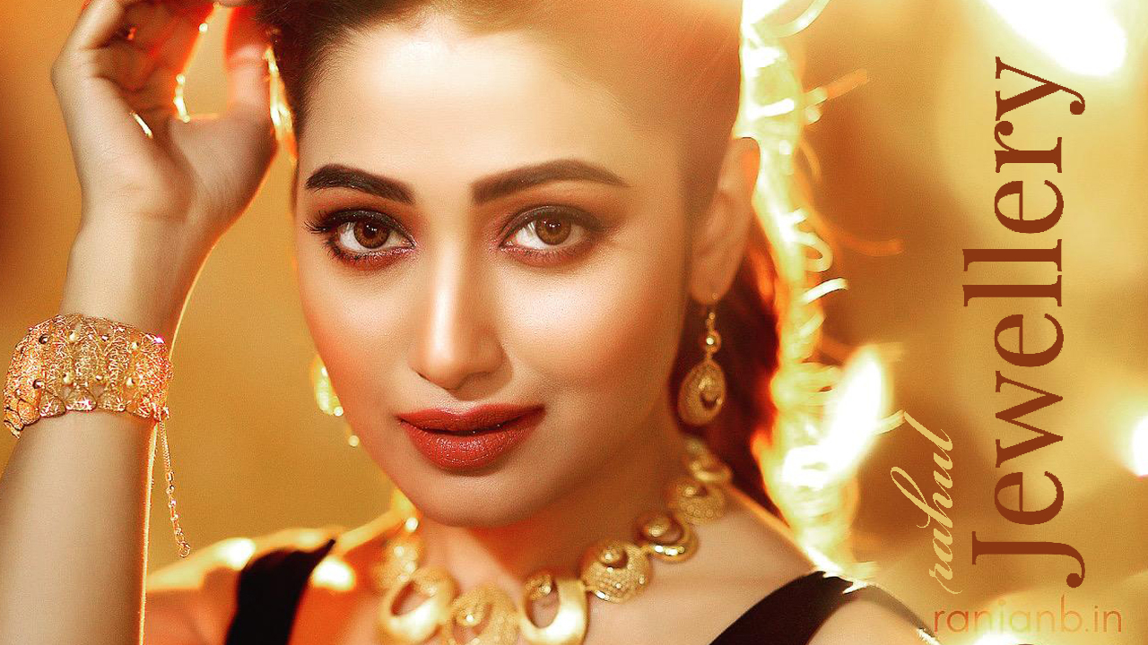 Elegant portrait of actress Sudipta Banerjee for Rahul Jewelers ad campaign by Ranjan Bhattacharya Photography. The actress is smiling while showcasing exquisite jewelry against a golden bokeh background.