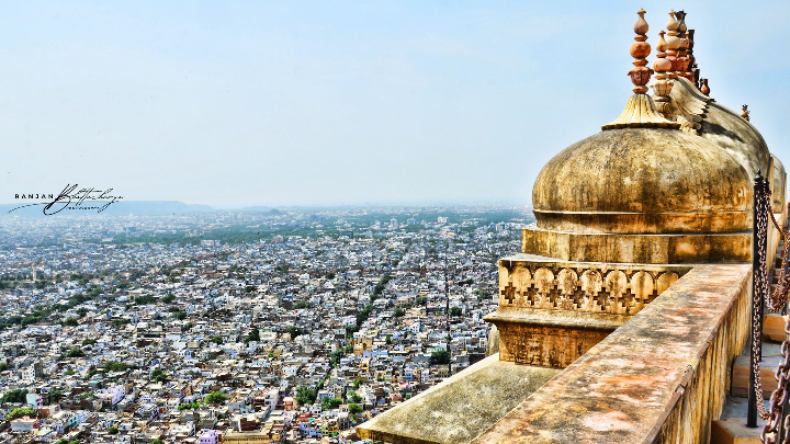 A high-angle view from Nahargarh Fort, overlooking the cityscape of Jaipur with a part of the fort in the foreground and the sprawling urban landscape in the background. Photo by Ranjan Bhattacharya.