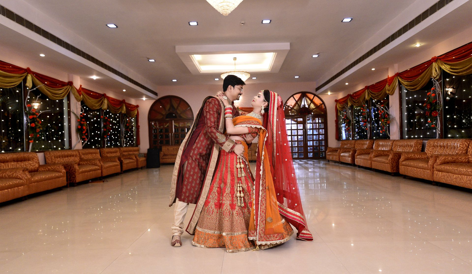 A joyful wedding moment where a guy hold his bride, captured by the best wedding photographer Ranjan Bhattacharya.